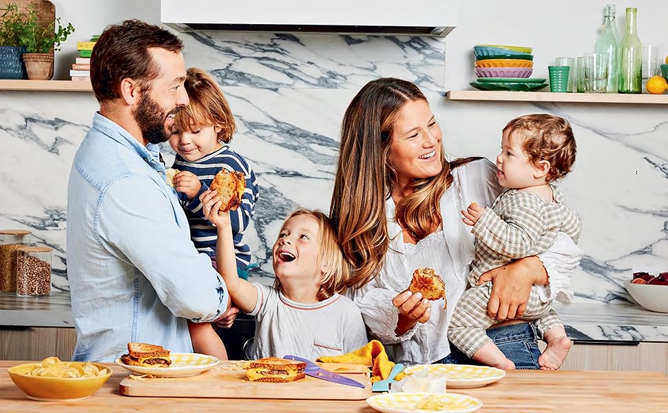 photo of a man, woman and their 3 small children eating grilled sandwiches and smiling