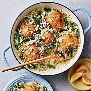 photo of a blue pot filled with chicken thighs, asparagus, and green rice