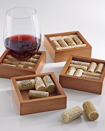 Wooden coasters made with wine corks. Red glass of wine sitting on display on top of coaster.