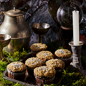 A photo of Black Moss Cupcakes on a tray next to candles