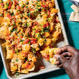 Ndambe Nachos with Black-Eyed Peas and Butternut Squash on a baking sheet