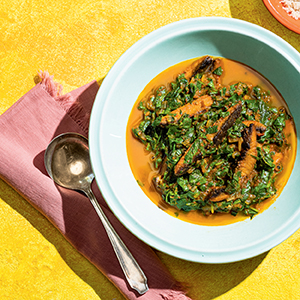 Spinach and Mushroom Efo Riro in a bowl with a spoon on the side