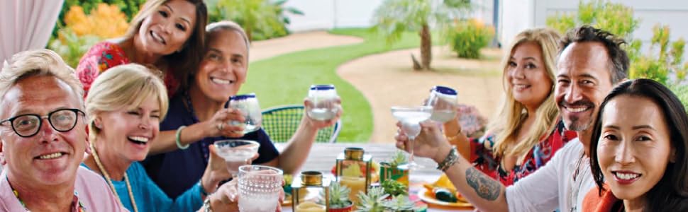 Chef Katie Chin and six of her friends sit around a large table celebrating with a good meal