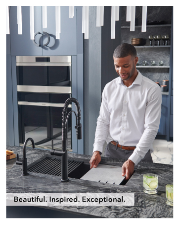 Man setting up accessories inside workstation sink.