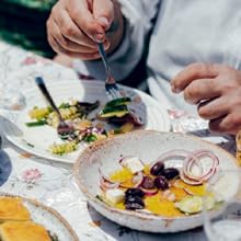 fresh salad and olives on a flower table cloth