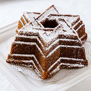 A brown cake with white icing sugar in the shape of the Star of David.