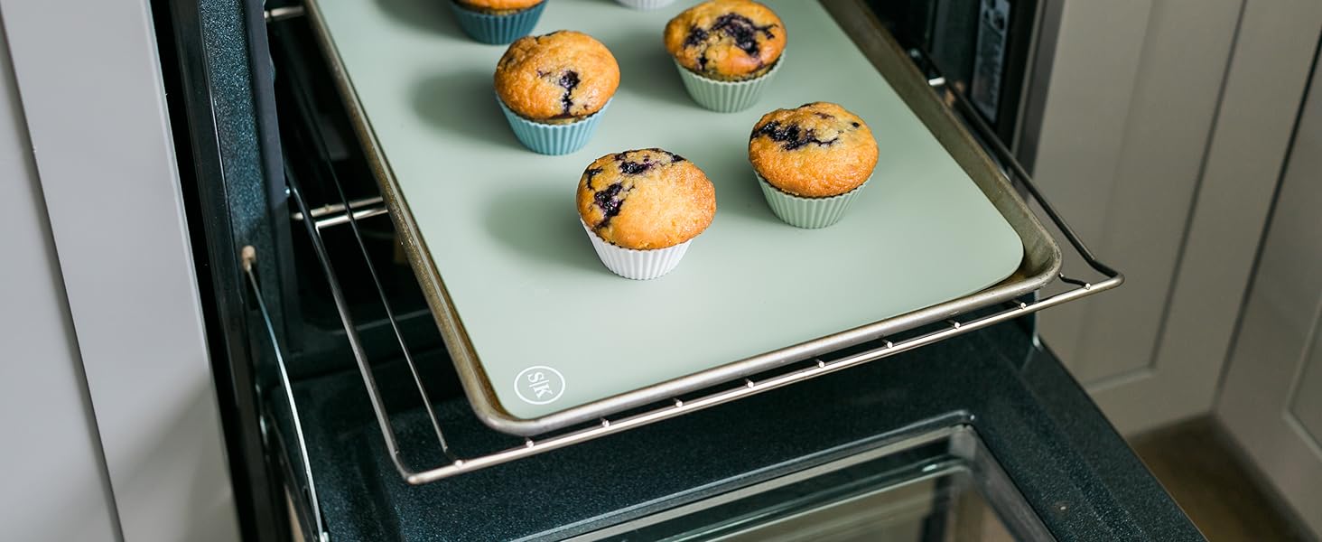 Blueberry muffins baked free-standing in silicone baking cups on a cookie sheet