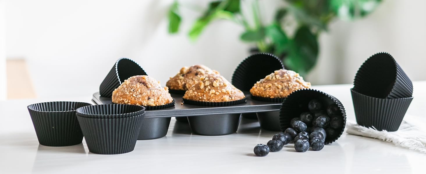 Matte black silicone baking cups with muffins and blueberries