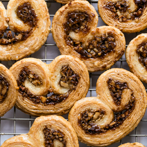 A photo of Baklava Palmiers on a wire baking rack