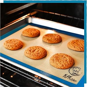 silicone baking mat with cookies on a baking sheet in the oven